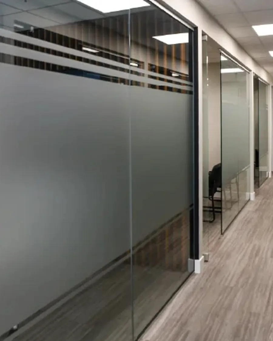 Frosted privacy film on a glass office partition in Calgary, softening the view while keeping the light